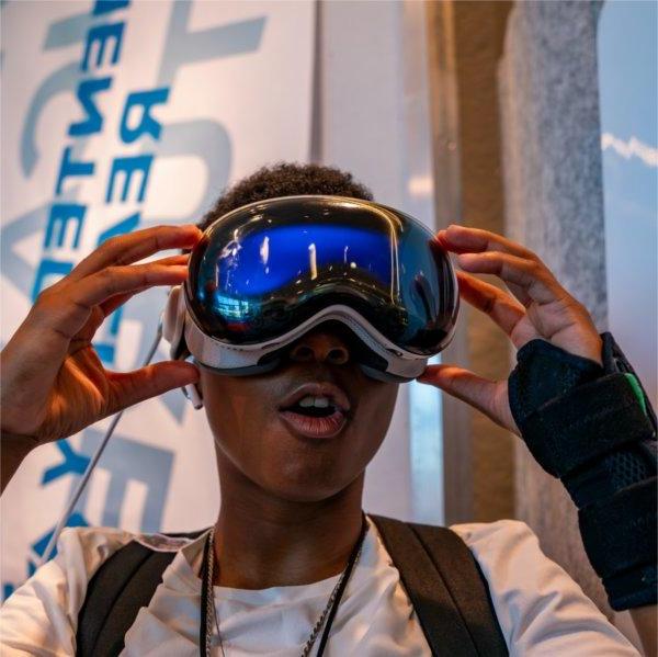 A person reacts to wearing virtual reality googles.